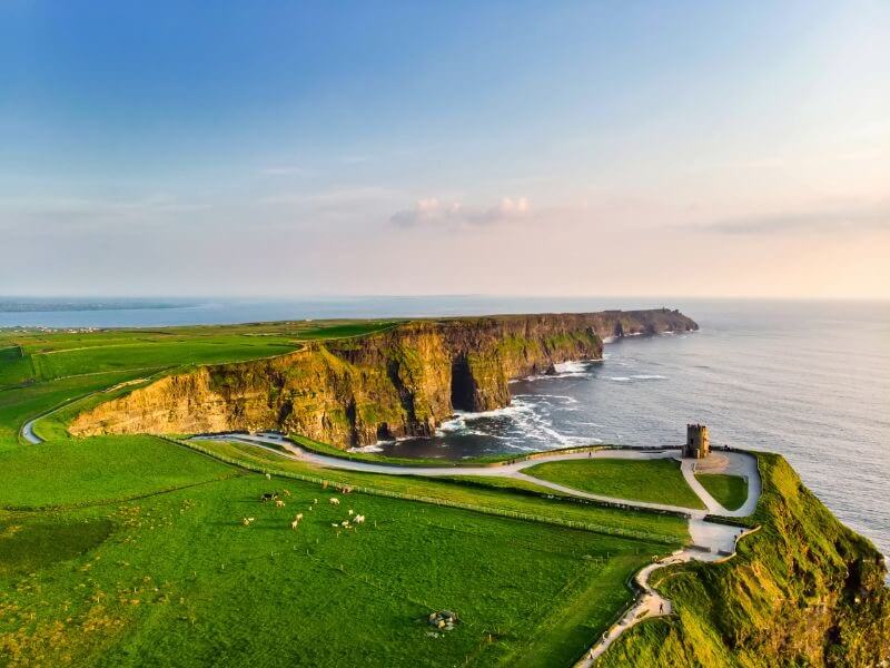 Lush green hills and dramatic cliffs stretching along the rugged Irish coastline.