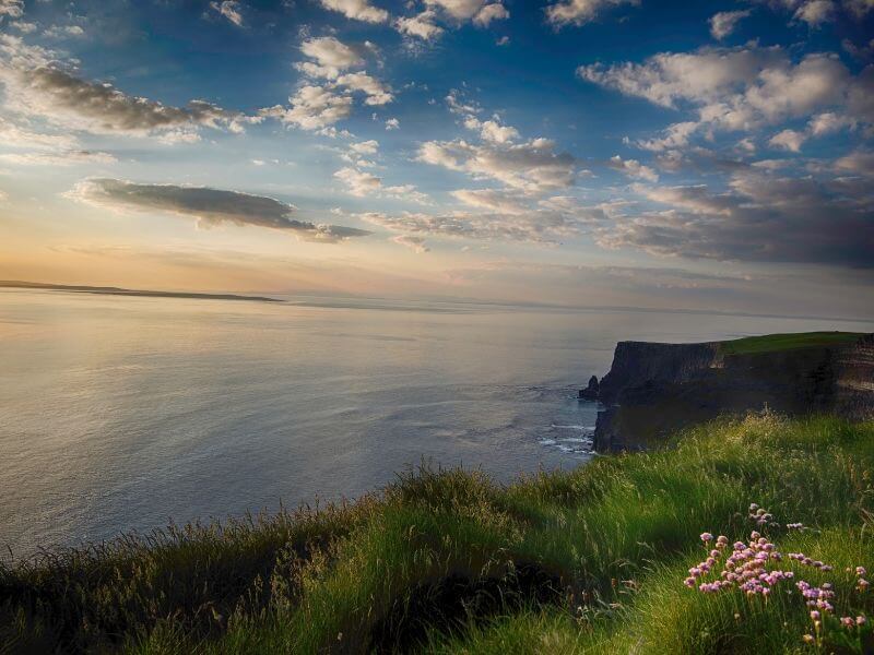 Panoramic seascape at sunset, showcasing the vastness of the Atlantic Ocean from the Cliffs of Moher.