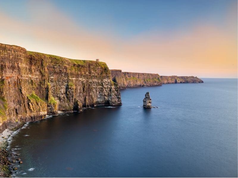 Breathtaking panoramic view of the Cliffs of Moher, Ireland, towering over the Atlantic Ocean.