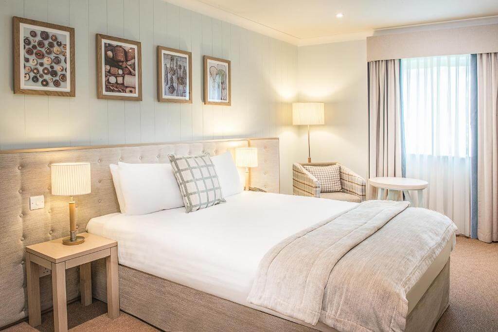 Cosy guest room in a luxury Cotswolds hotel, featuring upscale amenities and elegant furnishings.