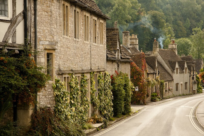 Castle Combe's charming cottages. An idyllic scence of fairytale cottages with wisps of smoke coming from the chimneys. It is one of the prettiest villages in the Cotswolds.