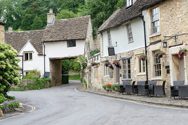 Charming village square with historic buildings in the Cotswolds.