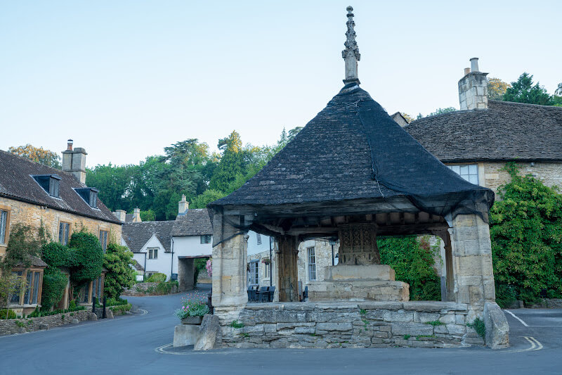 The iconic Market Cross stands proudly in the centre of Castle Combe, one of the best villages in the the Cotswolds.