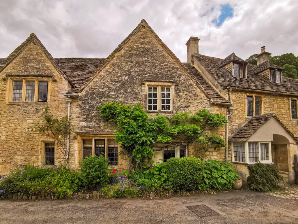 Quaint stone cottages nestled in the lush greenery of the Cotswolds.
