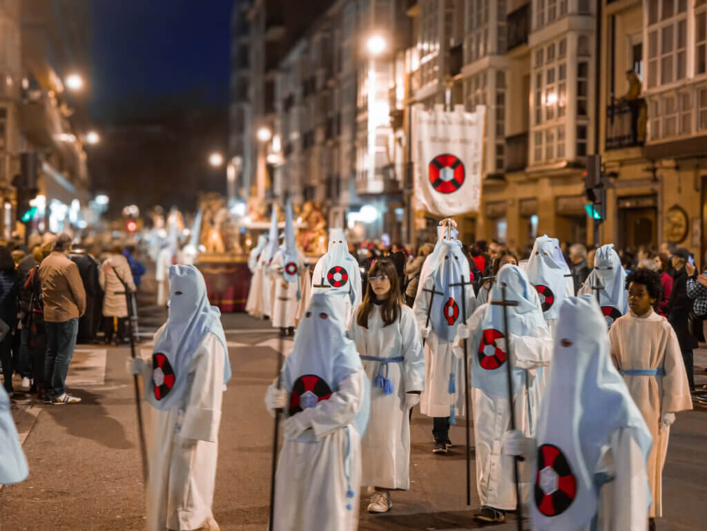Spectacular Semana Santa procession in Seville's historic streets, showcasing religious icons and traditional attire.