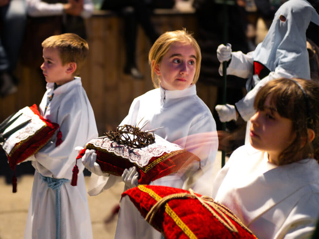 A solemn moment during Malaga's Easter parade, as participants carry religious icons through the city.