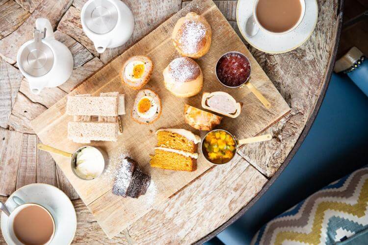 Afternoon tea in the Painswick Hotel, Cotswolds is a selection of perfectly trimmed sandwiches, pork pies, their infamous Scotch eggs, and warm scones.