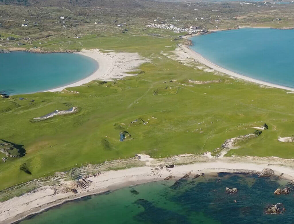 Aerial view of Dog's Bay and Gurteen Bay tombolo in Roundstone, Connemara. The waters are crystal clear turquoise blue and the sands are white and soft. One of the best beaches in Ireland.