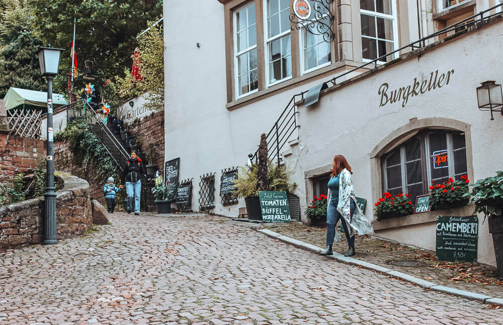 Woman wandering the cobbled streets of Heidelberg Germany.