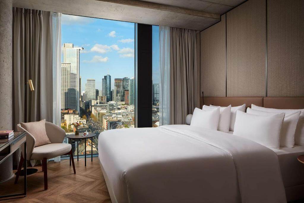 Elegant bedroom with city views at Hotel NH Collection Frankfurt City