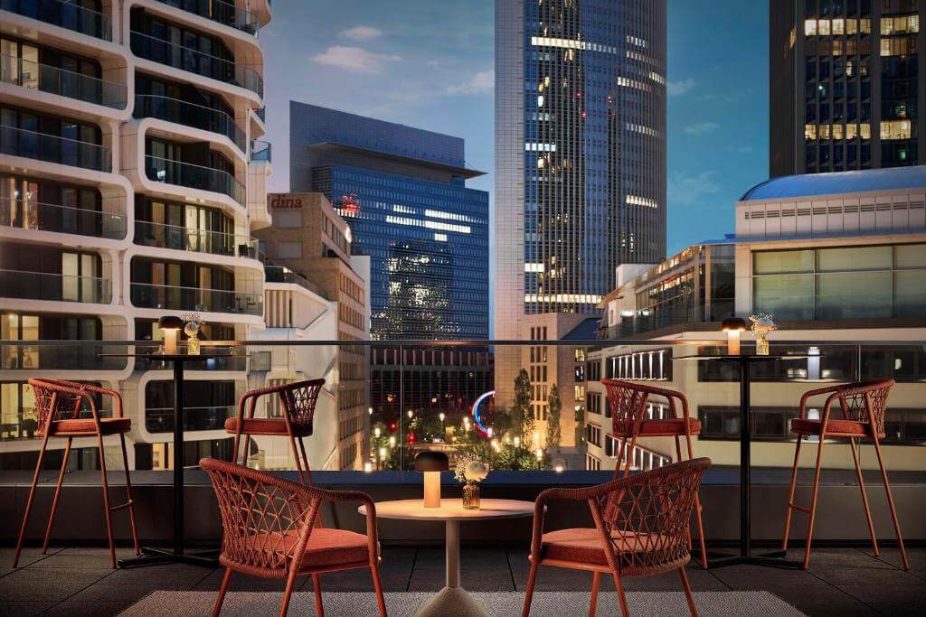 Rooftop terrace with stunning views of Frankfurt City at night at Hotel NH Collection Frankfurt City.