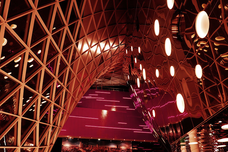 MyZeil shopping mall in Frankfurt lit up at night with its stunning glass façade and modern architecture.