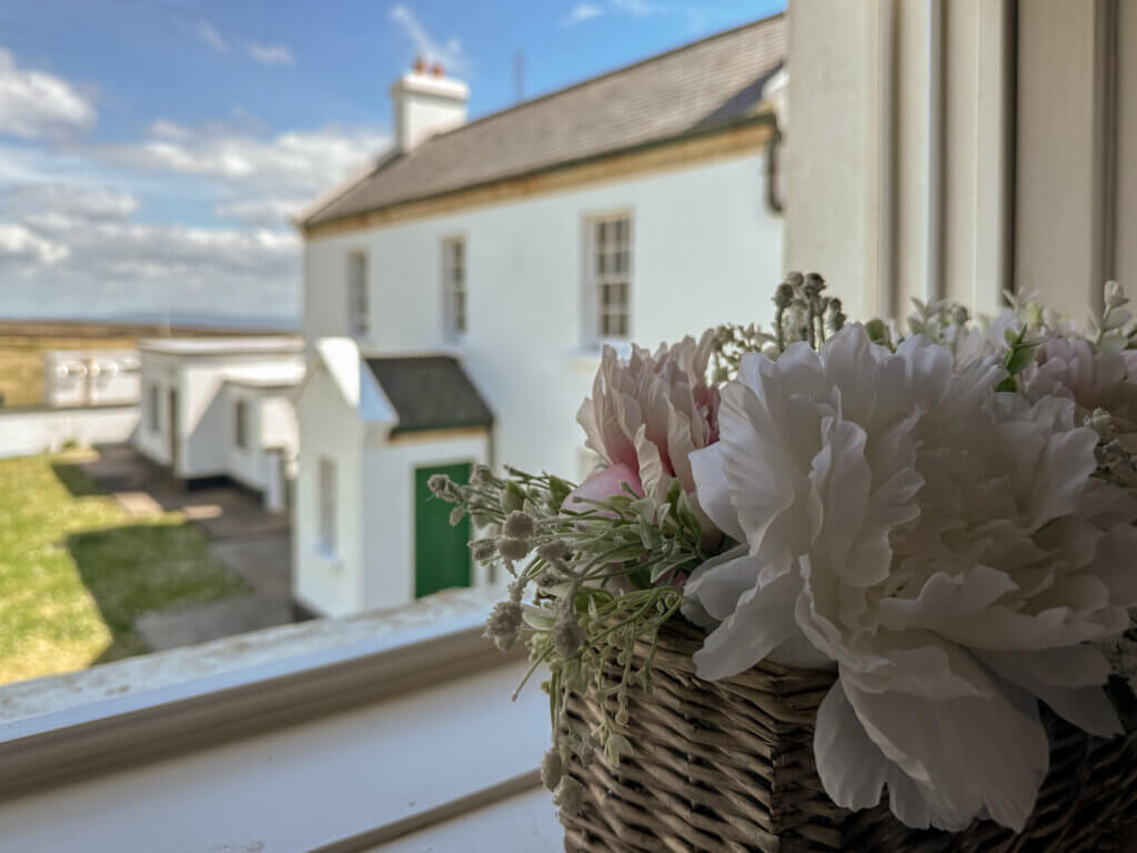 There is a comfortable seating area in the lighthouse cottage, offering views of the surrounding landscape.