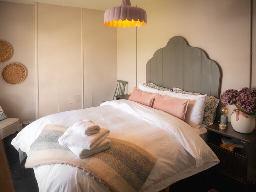 Cosy bed in the Loop Head Lighthouse cottage, adorned with soft linens and coastal decor.