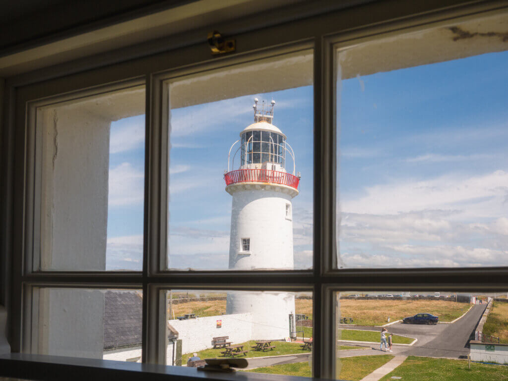 Loop Head lighthouse is framed by a window in the lighthouse attendant's cottage.