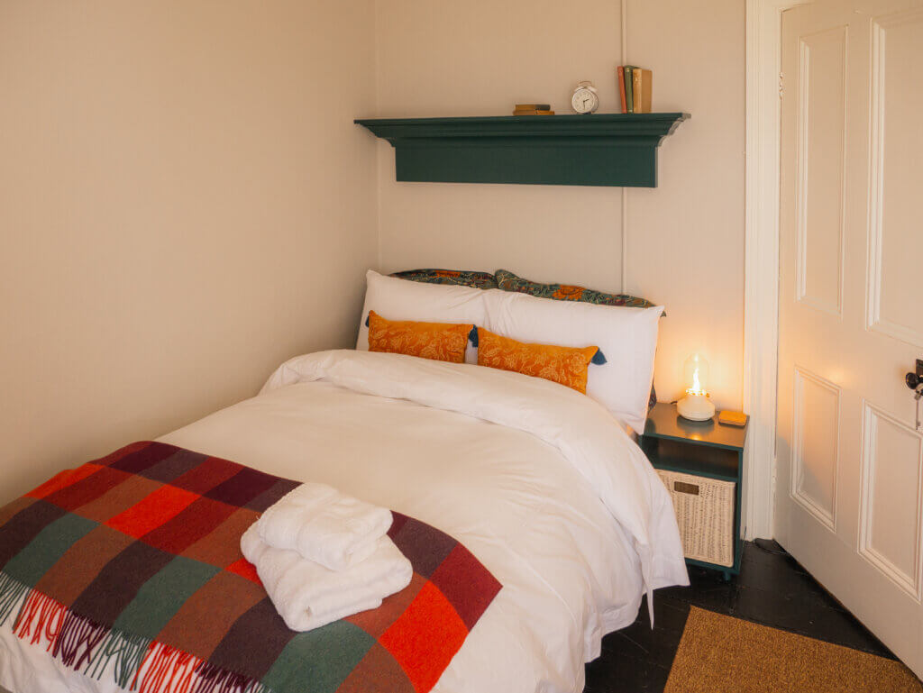 Bright and airy bedroom inside the Loop Head Lighthouse cottage, featuring coastal decor.