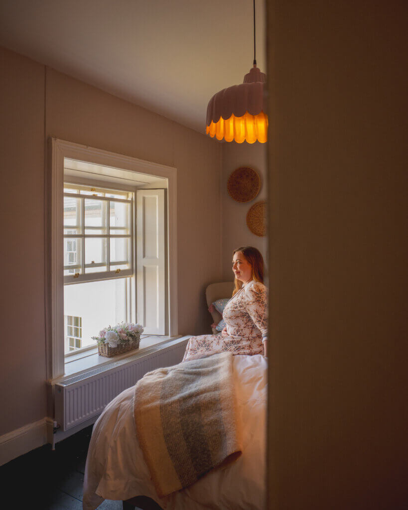 A quaint reading nook inside the lighthouse cottage, complete with a sea view.