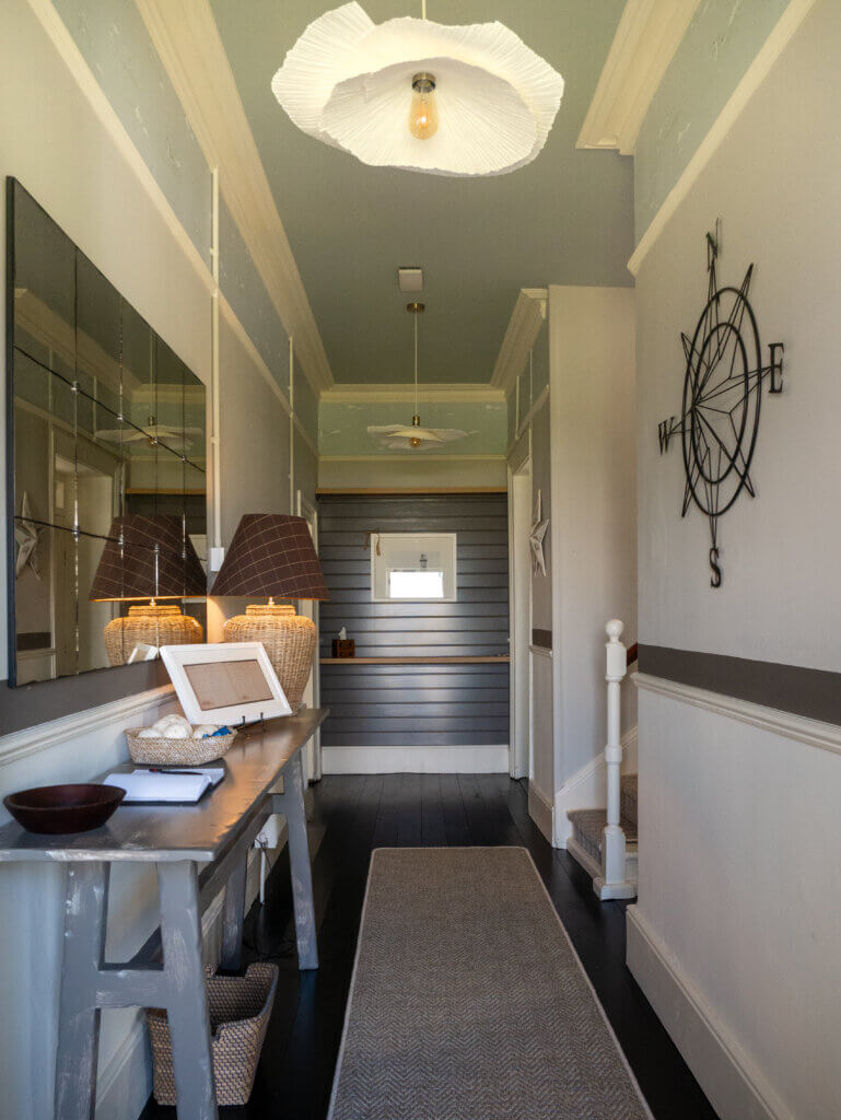 The hallway in the Loop Head Lighthouse cottage, decorated with nautical-themed artwork.